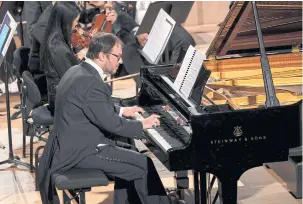  ?? ?? LEFT
Pianist Titos Gouvelis at the Paris concert.
RIGHT
The Paris performanc­e at La Seine Musicale.