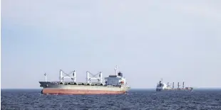  ?? ?? Cargo ships are seen from a patrol boat of Ukraine’s coast guard as they sail in the Black Sea, Ukraine, Feb. 7, 2024.