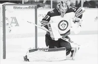  ?? ASSOCIATED PRESS FILE PHOTO ?? Winnipeg Jets goalie Connor Hellebuyck, like all NHL netminders, will be sporting a smaller chest protector this season as the league continues the process of shrinking equipment.