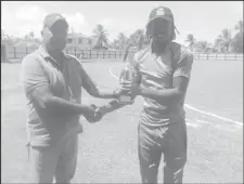  ??  ?? Trevon Griffith collects his man-of-the-match award from match referee, Moses Ramnarine