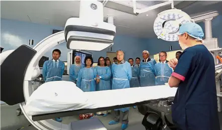  ??  ?? Heart of the matter: Dr Mahathir with Tun Dr Siti Hasmah Mohd Ali being briefed on the facilities at Cardiac Vascular Sentral Kuala Lumpur. — Bernama