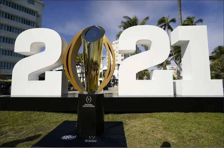  ?? Lynne Sladky The Associated Press file ?? The College Football Playoff national championsh­ip trophy is displayed in Miami Beach, Fla. The playoff could be expanding from its four-team format.