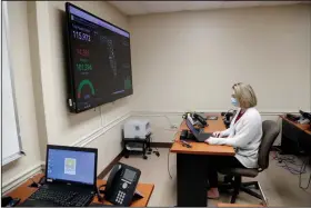  ?? (AP/Lynne Sladky) ?? Meghan Peck works on contact tracing earlier this month at the Florida Department of Health in Miami-Dade County. In state after state, local health department­s are doing the detective work to locate the contacts of coronaviru­s patients, and falling short on the number of workers needed to do the job.