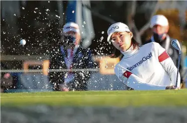  ?? Elizabeth Conley / Staff photograph­er ?? Hinako Shibuno of Japan gets the ball out of the bunker on the 18th hole during the third round of the 75th U.S. Women’s Open on the Cypress Creek Course at Champions Golf Club on Saturday.