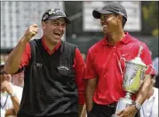  ?? CHRIS CARLSON / ASSOCIATED PRESS FILE ?? Rocco Mediate (left) jokes with Tiger Woods following Woods’ 19-hole playoff victory in the U.S. Open in 2008.