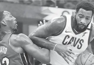  ?? PHOTOS BY TONY DEJAK/AP ?? Heat center Bam Adebayo plays tight defense Monday night against Cavaliers center Andre Drummond.