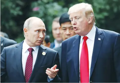  ?? (Jorge Silva/Reuters) ?? RUSSIAN PRESIDENT Vladimir Putin and US President Donald Trump chat during the official photo session at the Asia-Pacific Economic Cooperatio­n Summit in Danang, Vietnam, yesterday.