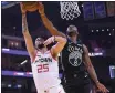  ?? THEARON W. HENDERSON — GETTY IMAGES ?? The Warriors’ Alec Burks blocks the shot of the Rockets’ Austin Rivers during the first half on Wednesday in San Francisco.