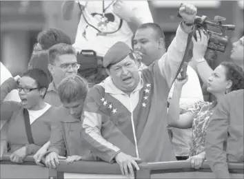  ??  ?? VENEZUELA’S President Hugo Chavez greets supporters in Caracas. — Reuters