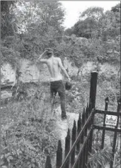  ??  ?? Ignoring the signs, Eric Goessele, 24, hopped the fence guarding the gorge at Webster’s Falls to get a better look. He is standing a couple of feet from the cliff’s edge.