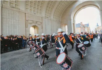  ?? OLIVIER MATTHYS/AP ?? Rememberin­g the fallen: A corps of pipes and drums marches Friday through the Menin Gate Memorial to the Missing in Ypres,
Belgium, during an Armistice Day ceremony. Since World War I ended in 1918, millions of visitors from as far away as the U.S., New Zealand and South Africa have flocked to memorials in France and Belgium to pay tribute to the fallen.