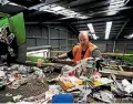  ??  ?? Adrian Lucas gets to work on lumpy flow of recycling into the Awapuni sorting facility.