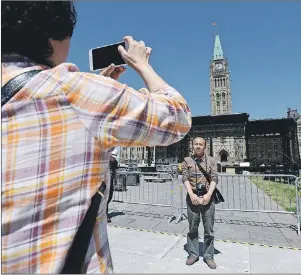  ?? CP PHOTO ?? Chinese tourists visit Parliament Hill in Ottawa on Wednesday, as preparatio­ns for Canada Day are underway. Be alert but not alarmed, police are urging Canadians who will congregate under the Peace Tower next month for Canada 150 celebratio­ns — a...