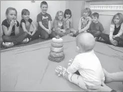  ?? Photo submitted by Palliser Regional Schools ?? Grade 1 students at Noble Central School get acquainted with baby Maggie during the Roots of Empathy program.