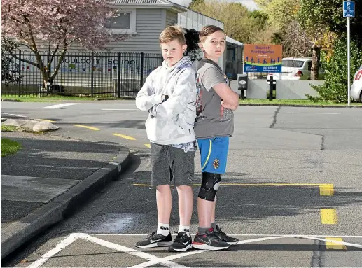  ?? ROSS GIBLIN/STUFF ?? Boulcott School pupils Harry Martin, 10, left, and Alex Jamieson, 11, want their bus stop shifted because they say it is dangerous.