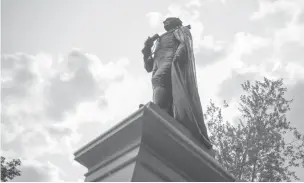  ?? PHOTOS BY IAN AUSTEN/THE NEW YORK TIMES ?? The statue of Sir John A. Macdonald, Canada’s fist prime minister, in Kingston, Ontario, Canada. The broad use of the name and image of Macdonald is being challenged because of his policies toward indigenous people.