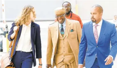  ?? KEVIN RICHARDSON/BALTIMORE SUN ?? Former state Sen. Nathaniel T. Oaks, center, walks into the federal courthouse with his attorneys Tuesday for his sentencing.