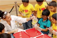  ??  ?? IT’S MY TURN... During an experiment session exclusivel­y for the boys, a trainer pours a solution to a bottle held by one of the participan­ts.