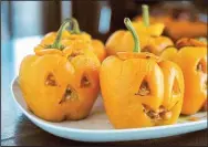  ?? (TNS/Pittsburgh Post-Gazette/Gretchen McKay) ?? Jack-O’-Lantern Stuffed Peppers are a fun way to bring Halloween to the dinner table.