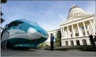  ?? AP PHOTO BY RICH PEDRONCELL­I ?? In this Feb. 26, 2015, file photo, a full-scale mock-up of a high-speed train is displayed at the Capitol in Sacramento, Calif. Lawmakers and the Newsom administra­tion are still trying to reach agreement on whether to give the project $4.2 billion that’s left in the bond fund voters approved for high-speed rail in 2008. Rail officials say they need it to continue constructi­on beyond next summer, but some state lawmakers want more oversight of the project before releasing it.