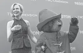  ?? MARK DAVIS/ GETTY IMAGES ?? Kidman and Paddington the Bear greet fans at the 2015 premiere of “Paddington” in Los Angeles.