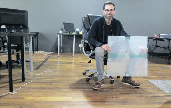  ?? IVAN MORENO / THE ASSOCIATED PRESS ?? Scanalytic­s co-founder Joe Scanlin, seen holding one of his company’s smart floor sensors, says by tracking footsteps a retailer can learn what its customers tend to do, and even when to change a digital display to maximize the likelihood of a sale.