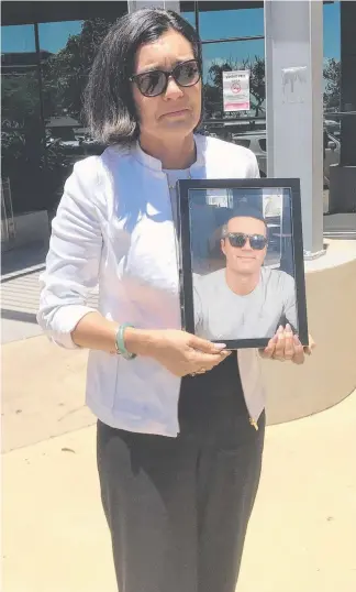  ??  ?? Rose Christian with a picture of her son Charlie Robertson outside court yesterday.