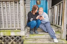  ?? Paul Buckowski / Times Union ?? Amanda Nacco sits on the porch with her son, Dylan Goering, 12, in Green Island. Dylan and his schoolmate­s have not had access to full-time instructio­n since the pandemic began in March 2020.