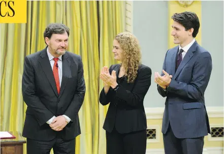  ?? SEAN KILPATRICK / THE CANADIAN PRESS ?? Prime Minister Justin Trudeau and Gov-Gen. Julie Payette applaud after Richard Wagner, left, is sworn in on Dec. 18 as the new Chief Justice of Canada.