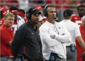  ?? JAY LAPRETE - THE ASSOCIATED PRESS ?? FILE - In this Sept. 22, 2018, file photo, Ohio State head coach Urban Meyer, right, and offensive coordinato­r Ryan Day watch from the sidelines against Tulane during the second half of an NCAA college football game, in Columbus, Ohio.