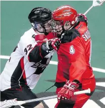  ?? CRYSTAL SCHICK/POSTMEDIA NEWS ?? Vancouver Stealth transition player Mitch McMichael, left, collides with Calgary Roughnecks transition player Geoff Snider in Calgary on Saturday. The Stealth won 18-14.