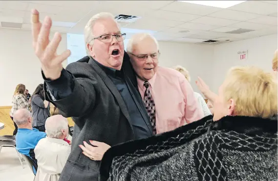  ?? TAYLOR CAMPBELL ?? Newly elected mayor of Essex Larry Snively, left, celebrates his win with 2,260 votes in a tight race Monday night.