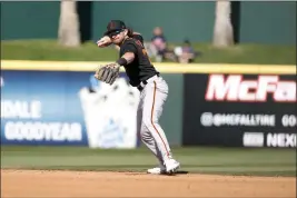  ?? CHRIS CODUTO — GETTY IMAGES ?? Brett Wisely (70) of the San Francisco Giants throws to first during the fifth inning of a spring training game at Goodyear Ballpark on March 02 in Goodyear, Arizona.