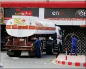  ?? AMR NABIL — THE ASSOCIATED PRESS ?? Workers refuel a tank Tuesday at a gas station in Jiddah, Saudi Arabia.