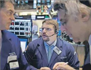  ?? AP PHOTO ?? Traders work on the floor at the New York Stock Exchange in New York Wednesday.