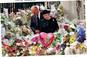  ??  ?? The Queen and Prince Philip inspect the piled flowers outside Buckingham Palace on the eve of the funeral