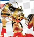  ?? AFP ?? Ferrari’s Sebastian Vettel kisses the trophy on the podium after winning the Bahrain Grand Prix on Sunday night.