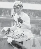  ?? SEAN M. HAFFEY/GETTY IMAGES ?? Mike Smith, at 52, becomes the second oldest jockey to win the Derby. It is his second victory in the race.