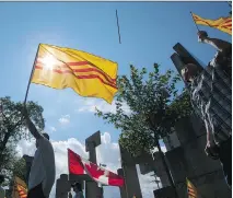  ?? DARREN BROWN/ OTTAWA CITIZEN ?? Protesters wave the Freedom Flag of Vietnam during a demonstrat­ion at the Human Rights Monument over the city’s decision to fly the official flag to mark the country’s national day.