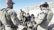  ?? RYAN REMIORZ / THE CANADIAN PRESS FILES ?? Canadian special forces soldiers speak with Kurdish fighters in 2017 in northern Iraq. Up to 250 Canadian troops will be part of a new NATO mission in Iraq.