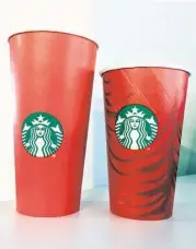  ?? Karen Bleier / AFP ?? These cups, debuted for the holidays by Starbucks earlier this month, have come under fire by some who say they don’t emphasize Christmas enough.