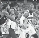  ?? KEN BLAZE/USA TODAY SPORTS ?? Cavaliers forward LeBron James drives to the basket against Raptors forward DeMarre Carroll during the first half Monday.