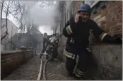  ?? EVGENIY MALOLETKA — THE ASSOCIATED PRESS ?? A rescue worker speaks on the phone while his team battles a fire in a house that was shelled by Russian forces in Kostiantyn­ivka, Ukraine, on Friday.