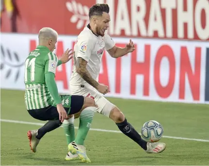  ?? CRISTINA QUICLER/AGENCE FRANCE-PRESSE ?? LUCAS Ocampos powers Sevilla past Real Betis in the resumption of La Liga.