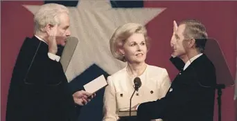  ?? Carolyn Cole Los Angeles Times ?? ‘A STEADY HAND’ California Chief Justice Malcolm Lucas, left, administer­s the oath of office to Gov. Pete Wilson for his second term as Wilson’s wife, Gayle, looks on in 1995. Lucas served as chief justice for nine years.
