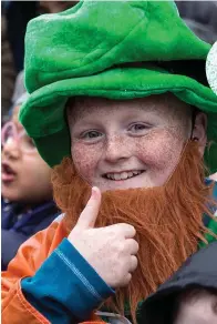  ??  ?? Keith O’Reilly from Dublin (above) enjoys the St Patrick’s Day parade in Dublin; right, Mylena Marquezini, Carolina Crisos Tobo and Giabriele Sencra, all from Brazil, donned the green at Dublin’s parade. Photos: Mark Condren, Stephen Collins