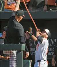  ?? KENNETH K. LAM/STAFF ?? Cowser drinks from the homer hose after going deep in the eighth inning Sunday against the Brewers.