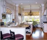  ??  ?? The gourmet kitchen features custom cabinetry and is fully equipped with appliances.