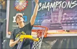  ?? AP; Getty Images ?? A CUT ABOVE: Caitlin Clark cuts down the net after scoring 30 of her 34 points after halftime in Iowa’s dramatic OT win.