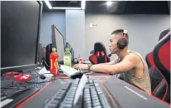  ?? ?? A man plays a computer game at an internet cafe in Beijing.